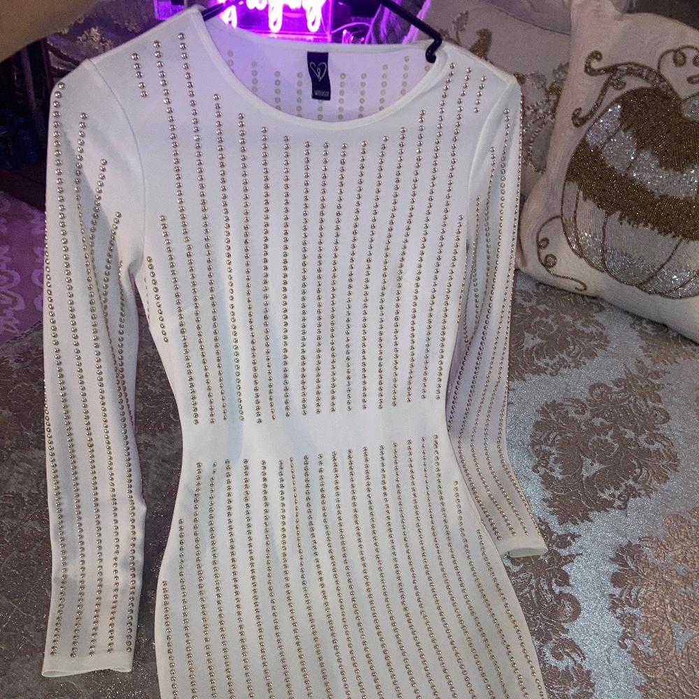 White, long sleeve dress, with a gold metallic design..